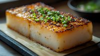 Grilled white fish fillet with crispy seared top, garnished with fresh herbs and spices on wooden serving board, close-up macro shot in natural lighting.
