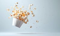 Flying popcorn explosion from white striped container against light background, dynamic food photography capturing motion and scattered kernels in mid-air.