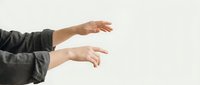 Professional hands reaching forward in gray sleeves against clean white background for business presentation and gesture concepts.