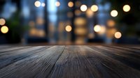 Empty wooden table surface with warm bokeh lights background for product display and food presentation in restaurant or cafe setting.