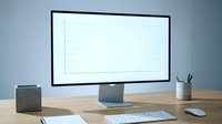 Clean modern workspace with computer monitor displaying blank lined paper template on wooden desk for productivity and organization.