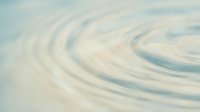 Soft swirling abstract waves in cream and pale blue tones create a serene, flowing background suitable for web design, presentations, and calming visual content.
