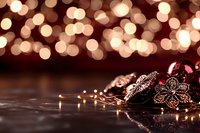 Festive Christmas ornaments with warm bokeh lights creating magical holiday atmosphere on dark wooden surface for seasonal decorations and celebrations.