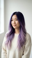 Young Asian woman with purple ombre hair wearing cream sweater smiling at camera in bright modern interior for lifestyle and beauty content.