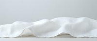 Crumpled white fabric textile isolated on neutral background, ready for design mockups, product presentations, and commercial applications.