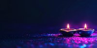 Traditional oil lamps with glowing flames on dark background with purple and pink glitter sparkles creating magical festive atmosphere.