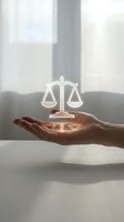 Hand holding glowing scales of justice symbol representing legal services, law firm consultation, attorney advice, and judicial balance in modern office.