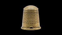 Brass thimble with textured dimpled surface and reinforced rim, isolated on transparent background. Ready for clipart, print-on-demand, sublimation, and design projects.