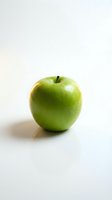 Fresh green apple isolated on white background with natural shadow, suitable for healthy eating, nutrition, and food-related design projects.