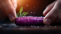Purple carrot being sliced on dark wooden surface with salt crystals and fresh herbs, dramatic lighting creates atmospheric culinary scene with bokeh effect.