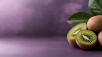 Fresh kiwi fruit sliced in half showing green flesh and black seeds on purple background with tropical leaves for healthy eating and nutrition concepts.