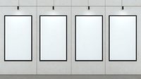 Four empty black frames mounted on light gray concrete wall in gallery setting, minimalist exhibition space for artwork display and presentations.