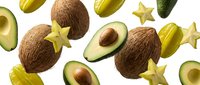 Tropical fruit pattern with coconuts, avocados and star fruit on white background. Fresh exotic produce for healthy eating and cooking recipes.
