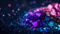 Vibrant macro shot of glitter particles in pink, purple, and turquoise colors creating magical bokeh effect against dark background, suitable for festive designs.