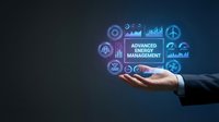 Businessman hand presenting advanced energy management system with digital icons and data analytics on dark blue background for sustainable solutions.