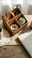 Wicker desk organizer caddy with compartments holding pencils, scissors and succulent plant on wooden table for home office organization and workspace storage.