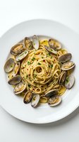 Spaghetti alle vongole with fresh clams arranged on white plate, garnished with parsley, overhead view for restaurant menu or food blog.