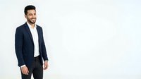 Young man with dark hair and beard, Middle Eastern or Mediterranean ethnicity, wearing navy blazer and white shirt, isolated on white background for corporate and business design use.