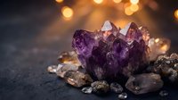 Purple amethyst crystal cluster with clear quartz stones on dark surface with warm bokeh lights creating mystical healing energy atmosphere.