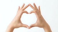 Hands forming heart shape gesture on white background isolated for love romance valentine design projects.