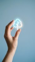 Hand holding glowing cloud computing icon with upload download arrows on blue background representing digital data storage and transfer technology.