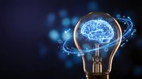 Glowing brain inside lightbulb with digital circuits on dark blue background representing artificial intelligence and innovation concepts.