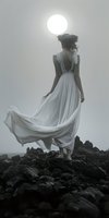 Woman with dark curly hair wearing flowing white gown standing on rocky terrain against bright sun, back view, ethereal and dramatic atmosphere for editorial and fashion use.