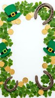 St. Patrick's Day frame with green leprechaun hats, horseshoes, gold coins and clover leaves on white background for festive holiday decorations.