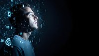 Young Caucasian businessman in suit looking up at digital data stream with glowing blue binary code and technology elements on dark background.