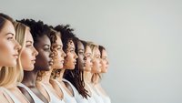 Diverse group of women in profile showing multicultural beauty and unity in neutral studio setting for inclusive campaigns.