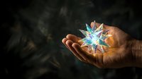 Mature male hand holding glowing multicolored star with light rays against dark background, representing innovation, energy, and magical power for creative concepts.