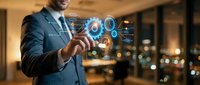 Professional businessman in dark suit interacting with futuristic holographic interface displaying digital icons and data visualization in modern office.