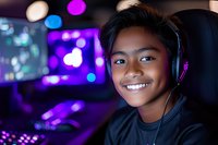 Young Asian male gamer wearing headphones smiles while playing video games in purple neon-lit room with gaming setup and bokeh lights in background.