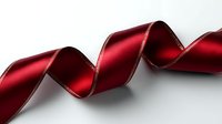Elegant deep red satin ribbon with silver edges curling gracefully against white background, isolated design element for gift wrapping and holiday decorations.