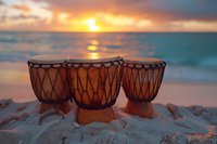 African djembe drums on beach sand at golden sunset with ocean waves and dramatic sky, creating peaceful meditation atmosphere for wellness and mindfulness.