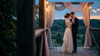 Romantic wedding couple embracing under elegant draped gazebo at sunset with string lights creating magical outdoor ceremony atmosphere.