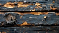 Weathered wooden planks with peeling navy blue paint revealing natural wood grain texture underneath, creating dramatic contrast and rustic pattern.