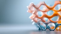 Macro view of orange and white honeycomb geometric structure with soft focus background showing modern architectural or scientific design elements.