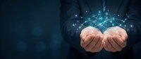 Businessman hands presenting glowing digital network connections with sparkling light effects on dark blue background for technology concepts.