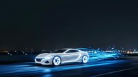 Silver sports car moving at high speed with blue light trails and digital effects on dark highway at night for automotive technology concepts.