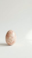Elegant pink Easter egg with ornate floral pattern on neutral background for spring holiday decorations and seasonal greeting cards.