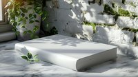White hardcover book on marble surface with natural sunlight casting leaf shadows, creating serene minimalist composition perfect for publishing, literature, or lifestyle content.