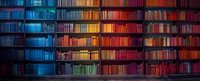 Panoramic view of library bookshelves with dramatic lighting creating gradient from cool blue to warm orange tones, perfect for education and knowledge concepts.