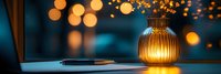 Glowing glass lamp on desk with bokeh lights creates cozy evening atmosphere. Pen and paper visible in warm ambient lighting against dark blue background.
