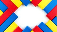 Colorful toy blocks arranged in diagonal pattern with white copy space in center, perfect for educational content, children's design projects, and playful backgrounds.