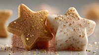 Festive star-shaped cookies with golden glitter decoration on warm background for holiday baking and Christmas celebration desserts.
