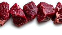 Fresh raw beef chunks arranged in a row, isolated on white background. Rich red color, marbled texture, perfect for food and culinary projects.