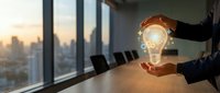 Businessman holding glowing light bulb with gear icons in modern conference room at sunset, symbolizing innovation and creative business strategy.