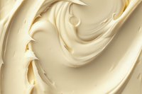 Creamy vanilla ice cream swirls creating smooth waves and soft peaks, macro photography showing rich dairy texture and luxurious dessert details in ivory tones.
