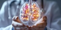 Glowing anatomical lungs held in medical professional hands against blurred hospital background, depicting respiratory health and pulmonary care concept.